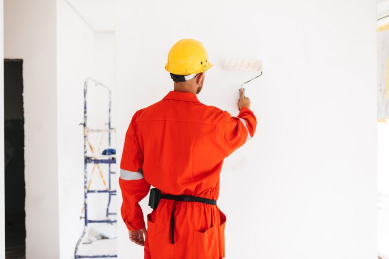 Painter applying fresh paint to an interior wall